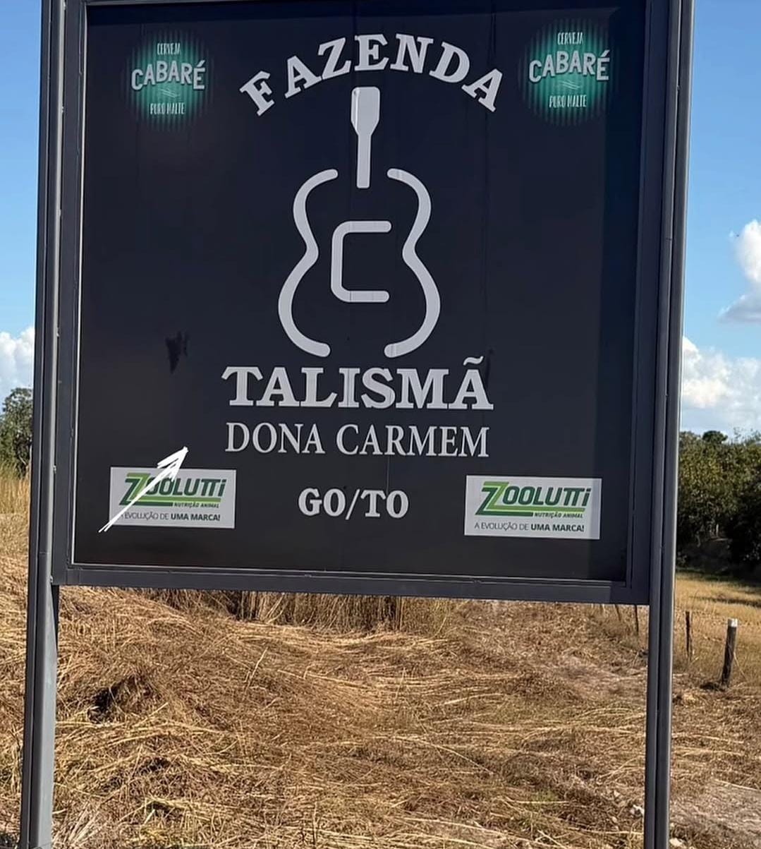 Imagem da entrada do local, com a placa da fazenda e o nome